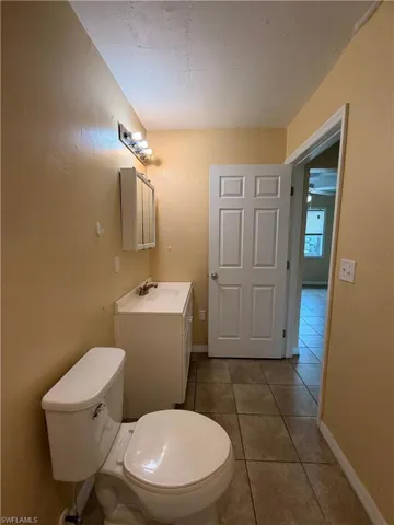 Half bathroom with vanity and light tile patterned floors
