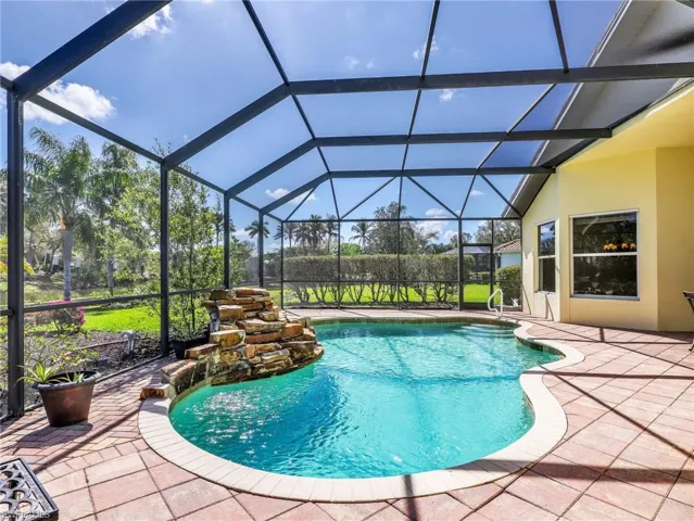 Outdoor pool with a sunroom, a lanai, and a patio