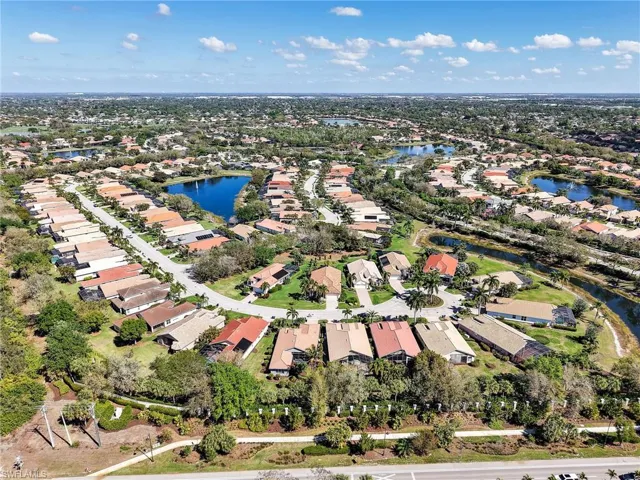 Aerial view of property and surrounding area with nearby suburban area and a nearby body of water