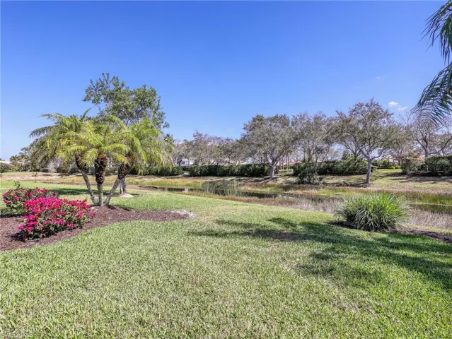 View of grassy yard with a water view