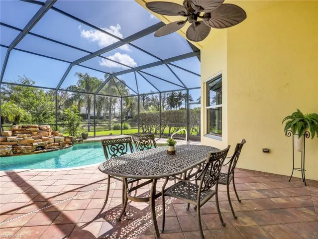 View of patio with an outdoor pool, a lanai, a sunroom, and outdoor dining area