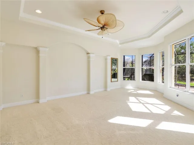Unfurnished room with a raised ceiling, light carpet, a ceiling fan, crown molding, and recessed lighting