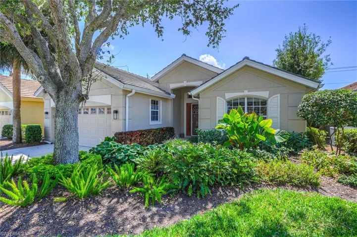 Ranch-style house with driveway, stucco siding, and a garage