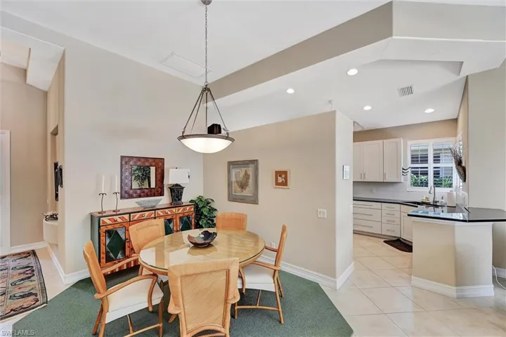 Dining space featuring light tile patterned flooring, baseboards, recessed lighting.