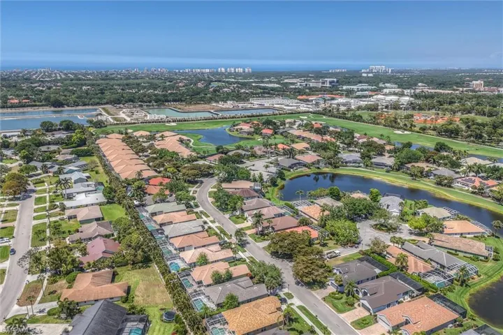 Aerial view with a residential view, golf course view, and a water view