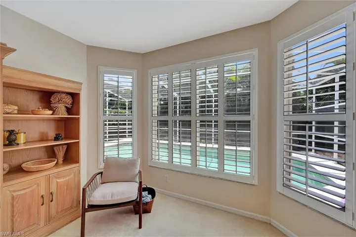 Sitting room featuring baseboards and light colored carpet