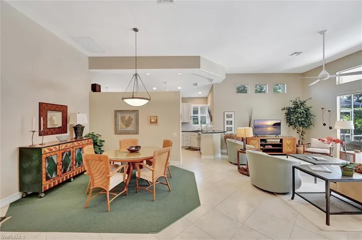 Dining room featuring light tile patterned floors, baseboards, ceiling fan, and visible vents