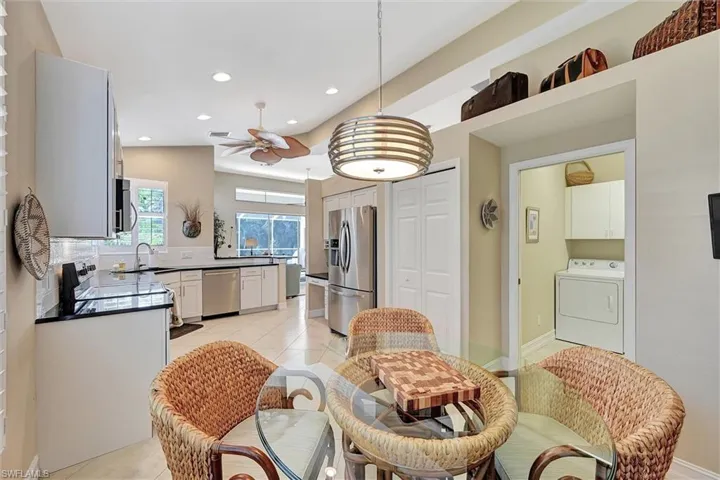 Dining space featuring a ceiling fan, washer / clothes dryer, light tile patterned floors, and recessed lighting