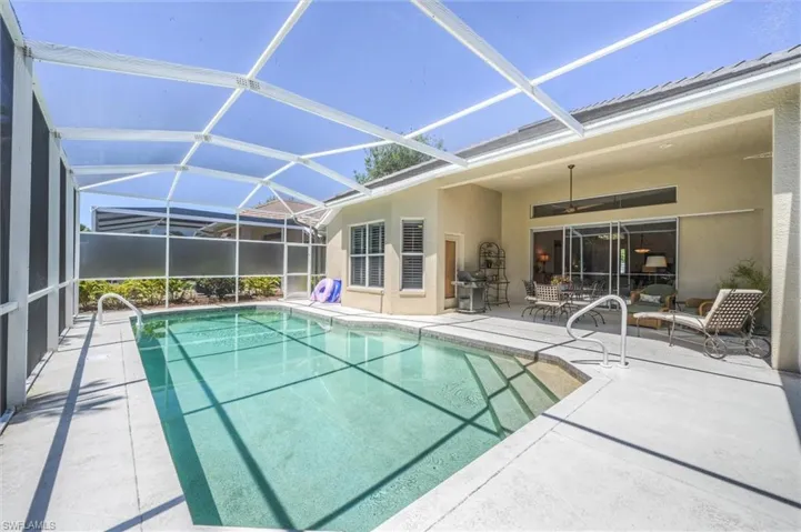 Pool with ceiling fan, a lanai, and a patio