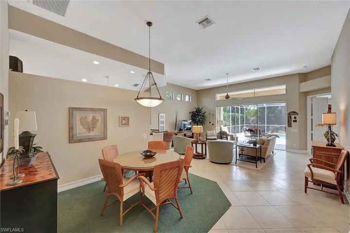 Dining room featuring light tile patterned floors, baseboards, and visible vents
