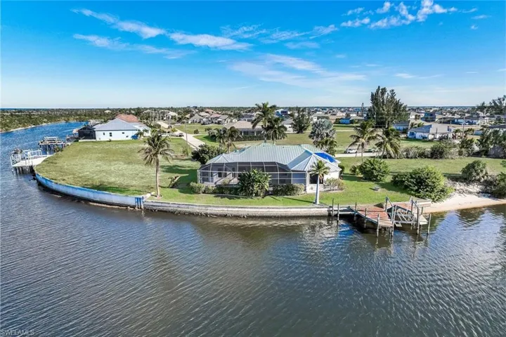 Aerial view of residential area featuring a nearby body of water