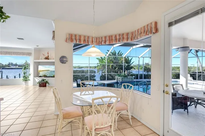 Dining area featuring a sunroom and tile patterned floors
