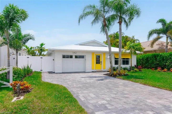 Ranch-style home with a garage and a front lawn
