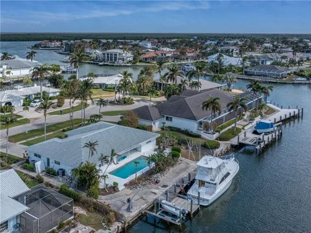 Birds eye view of property with a water view