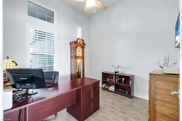 Home office with custom tile flooring and a ceiling fan