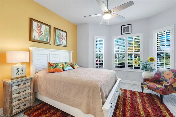 Bedroom featuring ceiling fan and custom tile flooring