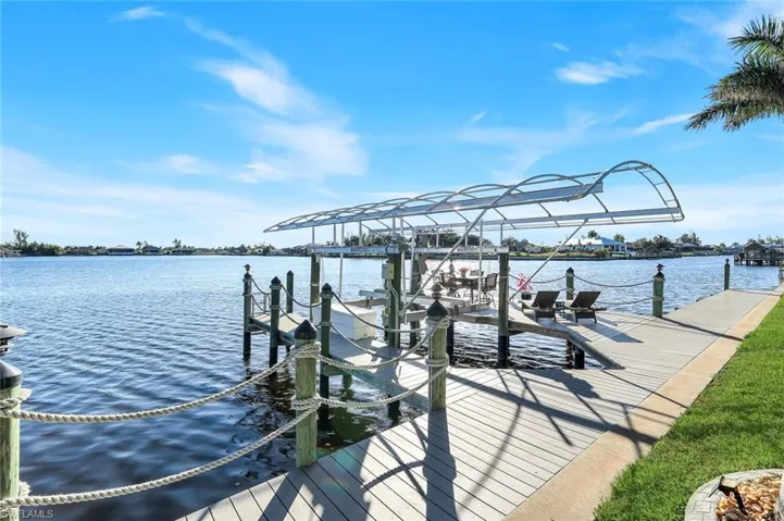 Dock with 10,000 lb boat lift and a water view of Lavedo Lake