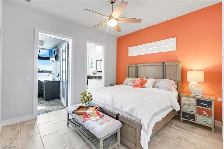 Bedroom with ceiling fan and ensuite bath