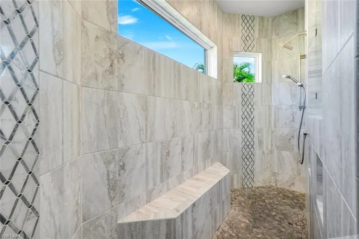 Full bathroom with a artistic design tile shower