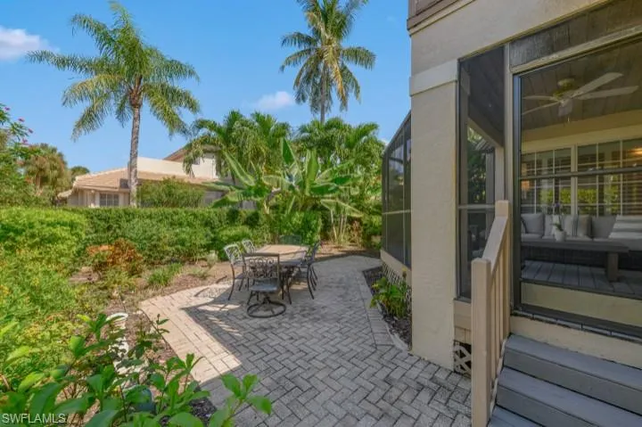 View of patio featuring a screened lanai and outdoor dining space