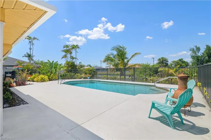 View of swimming pool with a fenced in pool, a patio area, and fence