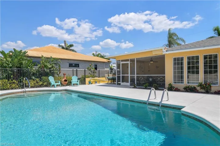 View of swimming pool with fence, a fenced in pool, a sunroom, and a patio area
