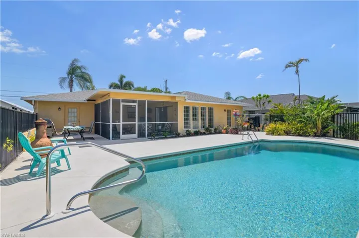 View of pool featuring fence, a fenced in pool, a patio, and a sunroom