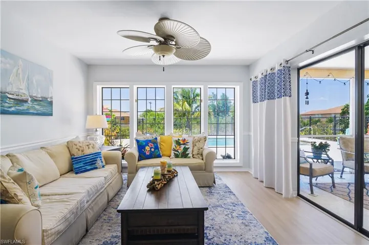 Living room with ceiling fan and wood finished floors