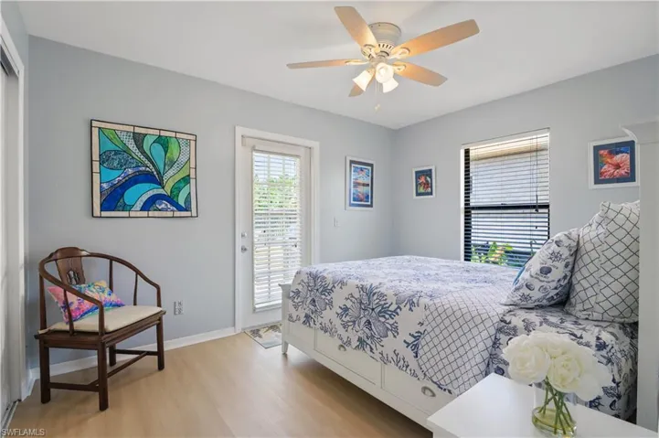 Bedroom featuring baseboards, ceiling fan, light wood-style flooring, and access to exterior