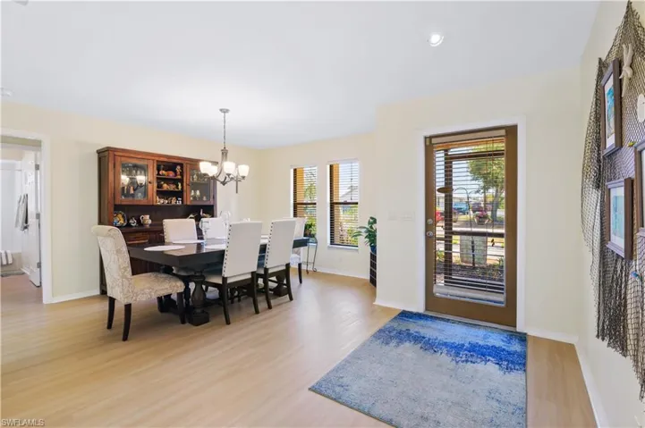Dining space featuring light wood-style floors, baseboards, and an inviting chandelier