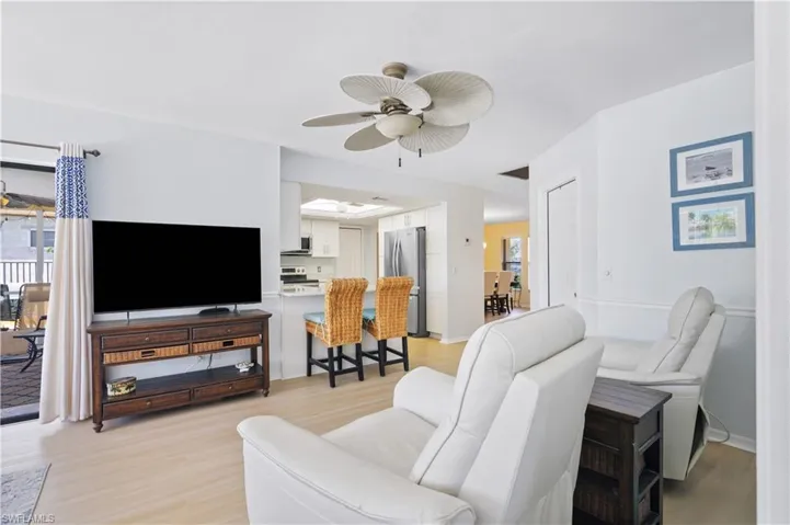 Living room featuring plenty of natural light, ceiling fan, and light wood finished floors