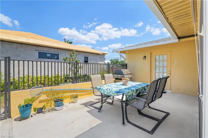 View of patio featuring outdoor dining area and a grill
