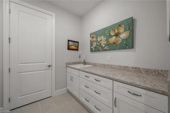 Bathroom with tile patterned floors and vanity