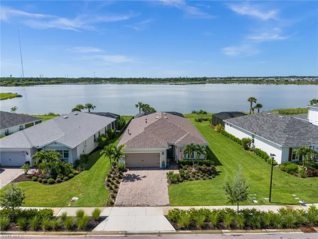 Aerial view of property and surrounding area featuring a large body of water