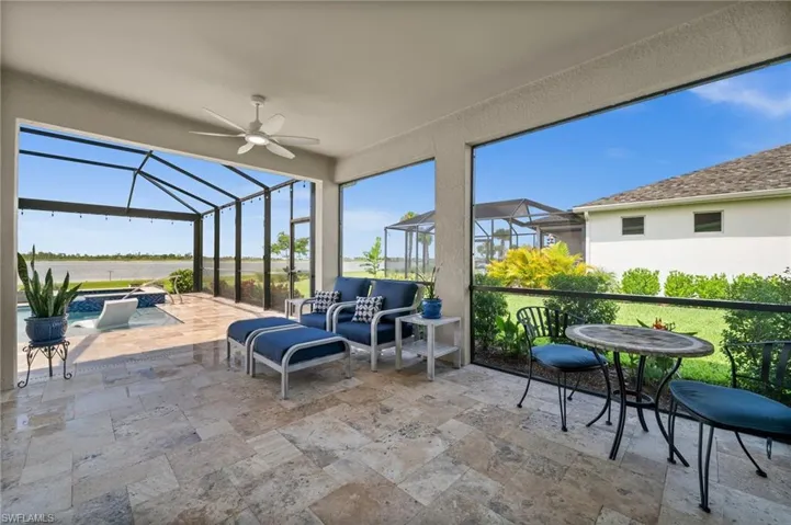 Sunroom / solarium with ceiling fan and an outdoor living space