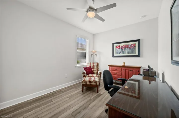 Office area with wood finished floors and a ceiling fan