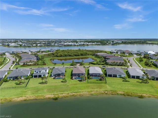 Aerial perspective of suburban area with a nearby body of water