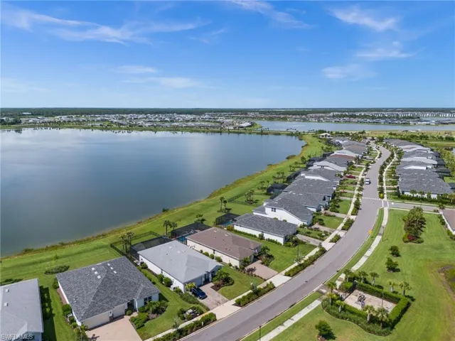 Aerial view of residential area featuring a nearby body of water