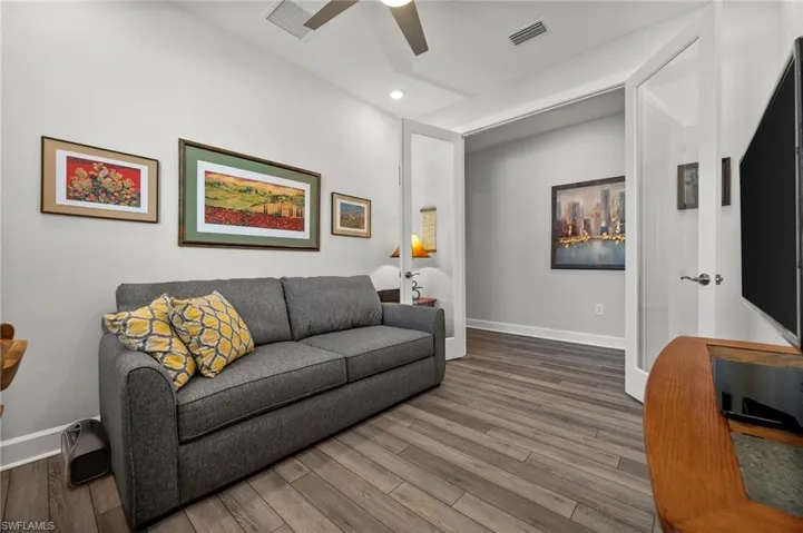Living area featuring a ceiling fan, wood finished floors, and recessed lighting