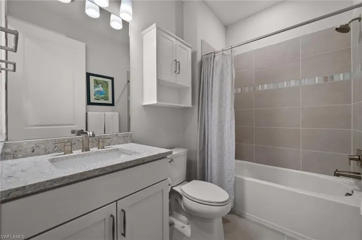 Full bath featuring vanity and shower / bath combo with shower curtain