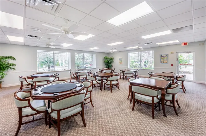 Dining room with a paneled ceiling, ceiling fan, and carpet