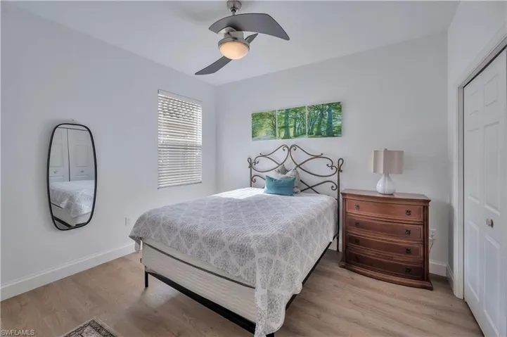 Bedroom with a closet, a ceiling fan, and light wood-type flooring
