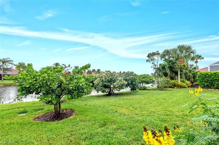 View of grassy yard with a water view
