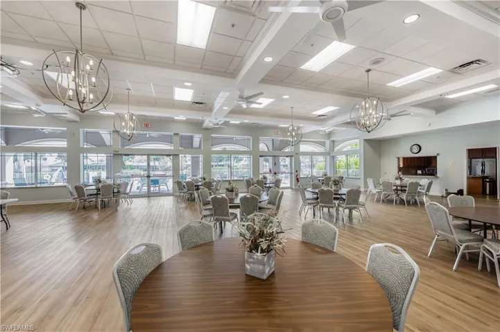 Dining space featuring a chandelier, light wood-style floors, beamed ceiling, ceiling fan, and recessed lighting