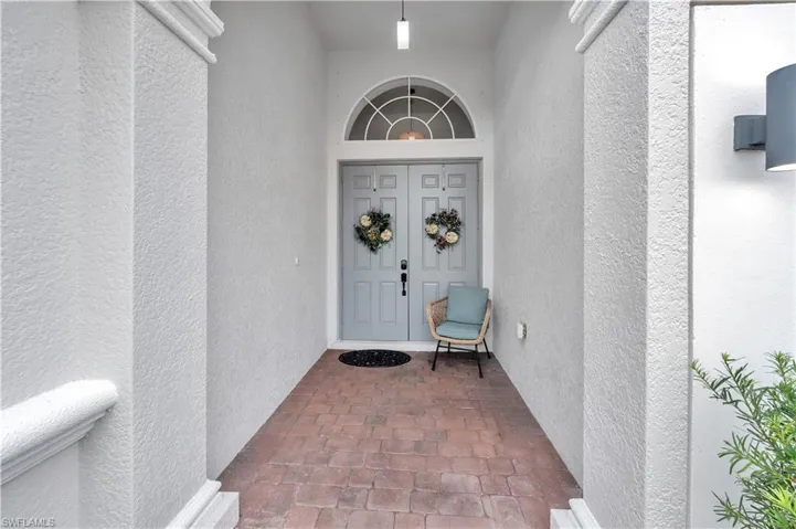 View of exterior entry featuring stucco siding