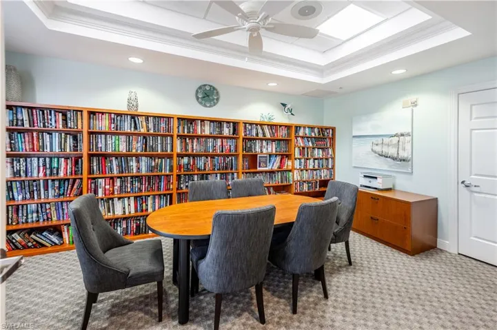 Office space featuring ornamental molding, recessed lighting, bookshelves, and a ceiling fan