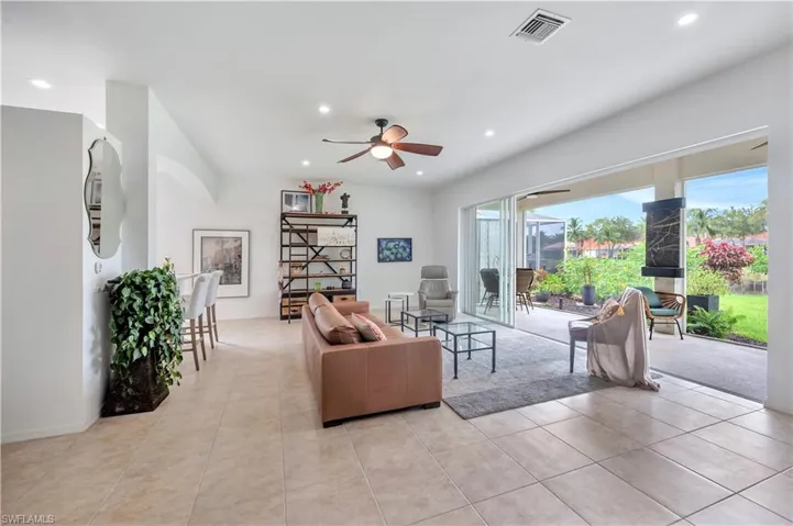Living area featuring recessed lighting, a ceiling fan, and light tile patterned floors