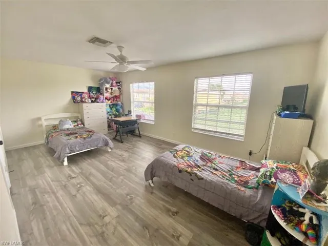 Bedroom featuring hardwood / wood-style floors and ceiling fan