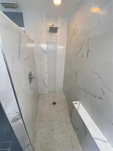 Bathroom featuring a tile shower