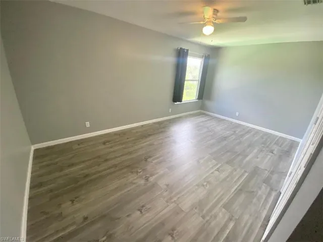 Spare room featuring wood-type flooring and ceiling fan